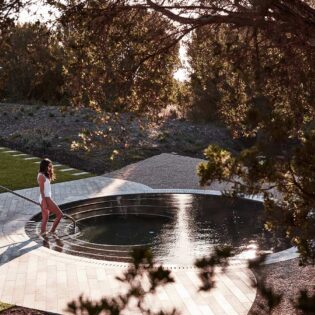 woman getting into a pool at Alba Thermal Springs