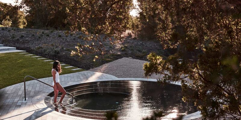 woman getting into a pool at Alba Thermal Springs