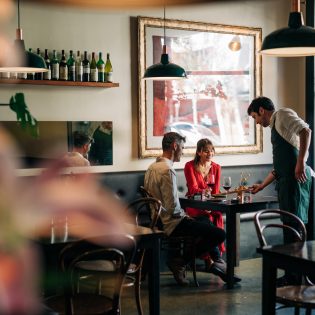 A couple being served at Fico restaurant in Hobart, Tasmania, Australia