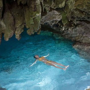 Woman swimming in a grotto on Christmas Island