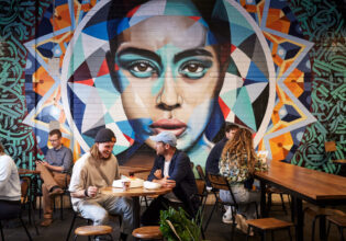 people dining near a vibrant wall art in Adelaide Central Market