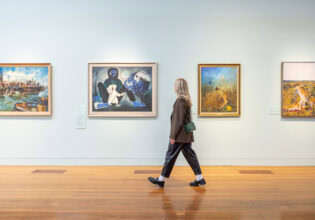 Woman admires artworks at Bendigo Art Gallery