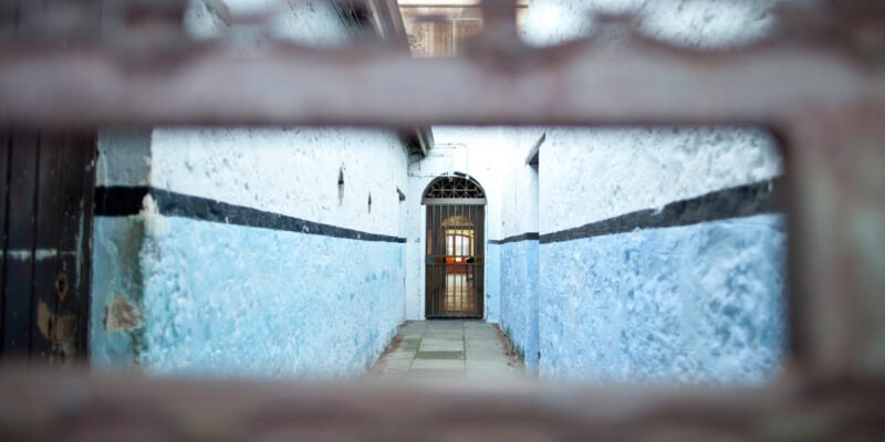 peeking through a small hole in the corridor of Fremantle Prison