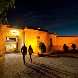 two people entering Old Mount Gambier Gaol at night
