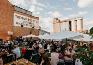 the Backyard and Tremains Mill filled with people dining at The Victoria pub, Bathurst