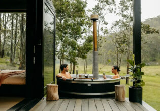 a couple relaxing in the outdoor tub at Billy’s Hideaway, Hunter valley
