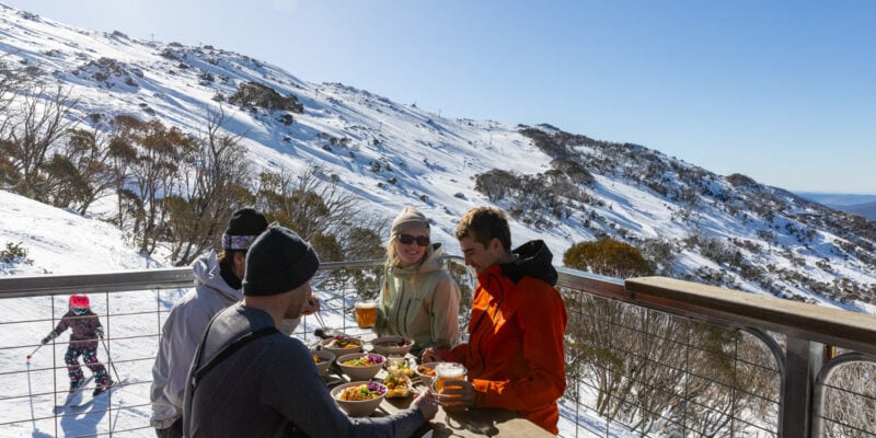 friends dining on the outdoor deck of Black Sallees, Thredbo