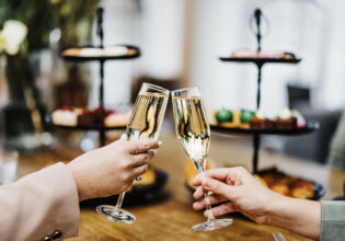 clinking glasses at Ms Mary High Tea, Crystalbrook Kingsley