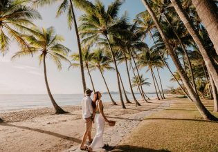 a couple walking on the Palm Cove Beach