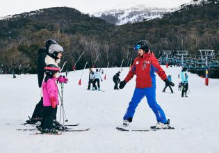 a family learning how to ski with an instructor at Thredbo in the Snowy Mountains