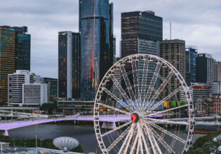 the top view of the Wheel of Brisbane with tall buildings in the background