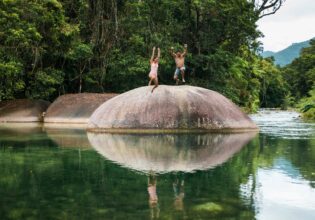Couple jump off the Babinda Boulders near Cairns