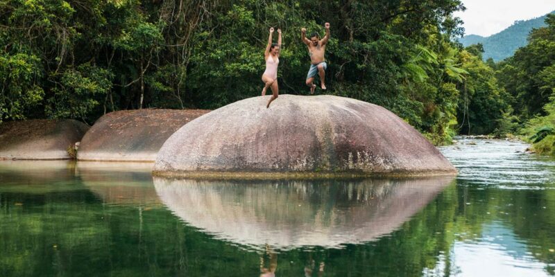 Couple jump off the Babinda Boulders near Cairns