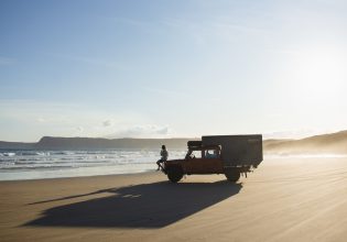 a person sitting on a 4WD vehicle on Cloudy Bay