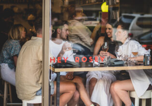 A group gathers for drinks at Hey Rosey in Orange