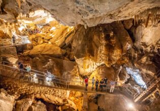 A group of people tour the intricate Jenolan Caves