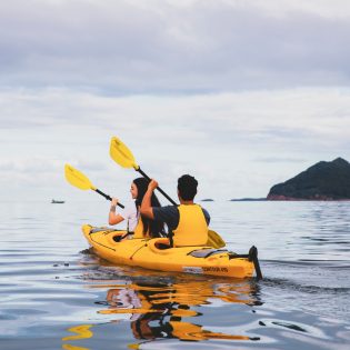Couple enjoying a day of kayaking along the Karuah River off Jimmys Beach, Hawks Nest.