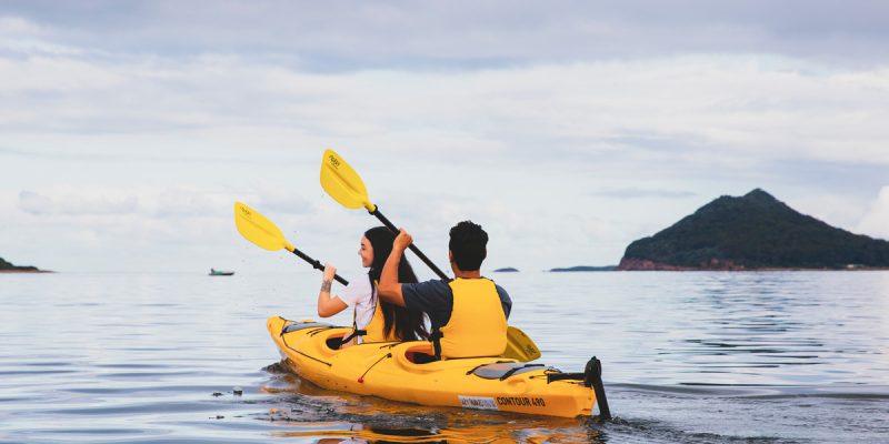 Couple enjoying a day of kayaking along the Karuah River off Jimmys Beach, Hawks Nest.