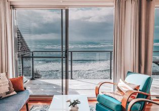 an oceanfront villa with glass windows facing the sea in Pacific Lodge, Yamba