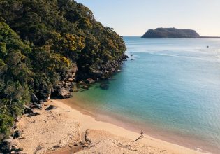 Man enjoying a morning walk along Resolute Beach in Ku-ring-gai National Park.