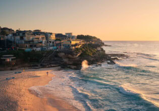 Surfer at Tamarama Beach at sunrise