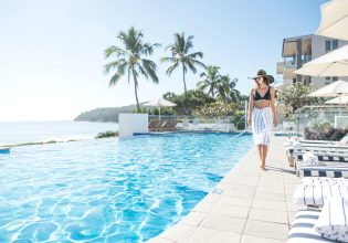 Woman walking by the pool at Tingirana Noosa