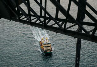 Sydney Ferry passes under the Sydney Harbour Bridge