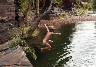 Kid jumps into Karijini National Park gorge